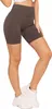 A woman wearing brown biker shorts and white sneakers, shown from the waist down against a white background. Produktbild-Vorschau