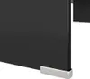 A close-up view of the bottom corner of a black TV stand or monitor riser, showing its sleek design and silver feet. Voir les images du produit