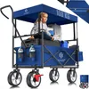 A young girl sits in a blue foldable wagon filled with luggage, water bottles, and other items, with a canopy overhead. Produktbild-Vorschau