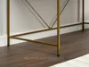 Close-up view of the base of a desk, showing its gold metal legs and the dark wood floor. Voir les images du produit