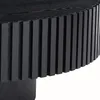 A close-up view of the side and top of a black round coffee table with a slatted design. Produktbild-Vorschau