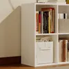 A white modular cube shelf unit filled with books and a fabric storage bin. Podgląd zdjęcia produktu
