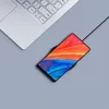A smartphone is wirelessly charging on a charging pad next to a laptop. Produktbild-Vorschau