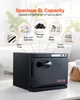 A black towel warmer is shown in a bathroom setting, with various items that can be disinfected or warmed displayed around it. Produktbild-Vorschau