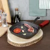 A cast iron grill pan with a piece of lamb, tomato, and garlic on a wooden board, with kitchen accessories in the background. Náhľad obrázku produktu