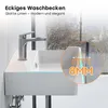 A modern white ceramic sink with a silver faucet, set against a blurred background of a window with a view. Anteprima dell’immagine prodotto