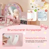 A close-up marketing image of a pink children's vanity table, showcasing its features like a mirror with LED lights, accessories, and safety instructions. Náhled obrázku produktu