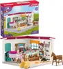A toy horse stable playset and its packaging. Produktbild-Vorschau