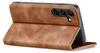 A brown flip case for a smartphone is shown from a side angle, with the phone inserted and the cover open. Produktbild-Vorschau