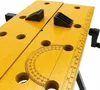 A close-up view of a yellow workbench with various markings and tools. Náhled obrázku produktu