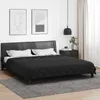A black bed with white pillows and a black duvet is shown in a bedroom setting. Produktbild-Vorschau