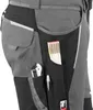 A close-up view of the side pocket of work pants, showing various tools stored within. Produktbild-Vorschau