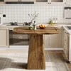 A rustic wooden dining table with a pedestal base is shown in a kitchen setting. Náhľad obrázku produktu