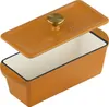 A close-up, studio shot of an orange cast iron loaf pan with its lid slightly ajar. Produktbild-Vorschau