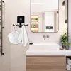 A bathroom setting with a rotating hook rack holding a loofah and a towel, a sink, and a mirror reflecting a wall-mounted unit and lighting. Produktbild-Vorschau