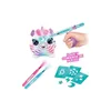 A hand holding a spray toy gun pointed at a plush unicorn toy, with stencils and markers nearby. Náhľad obrázku produktu