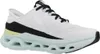A side view of a white athletic shoe with black and light green accents. Voir les images du produit