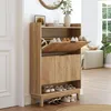 A wooden shoe cabinet with open drawers and shoes inside, placed in a hallway next to a door and a window. Podgląd zdjęcia produktu