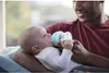 A father is feeding his baby with a bottle. Anteprima dell’immagine prodotto