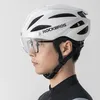 A man wearing a white Rockbros bicycle helmet with a clear visor and glasses. Produktbild-Vorschau