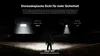 A person stands in a dark field, illuminated by two different flashlight beams. Anteprima dell’immagine prodotto