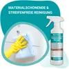 A hand wearing a yellow glove cleans a white cabinet with a blue cloth, next to a spray bottle of cleaning product. Produktbild-Vorschau