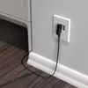 A close-up view of a black internet cable plugged into a white wall socket. Anteprima dell’immagine prodotto
