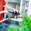 A person is rinsing a pot in a kitchen sink. Voir les images du produit