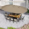 An outdoor dining set with a large double umbrella providing shade. Podgląd zdjęcia produktu