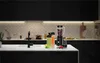 A modern kitchen counter with a blender, to-go cups, and fruit. Podgląd zdjęcia produktu