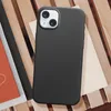A black iPhone 15 protective case is shown on a wooden surface, with some papers underneath. Produktbild-Vorschau