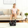 A woman is sitting on a couch using a mini elliptical trainer. Produktbild-Vorschau
