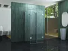 A modern bathroom with a glass shower enclosure, green tiled walls, a sink, and a toilet. Produktbild-Vorschau