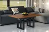A living room scene with a modern sectional sofa and a wooden coffee table in the foreground. Voir les images du produit