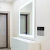 A smart thermostat mounted on a wall next to a large mirror and a white dresser. Podgląd zdjęcia produktu