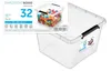 A clear, studio shot of a transparent plastic storage box with black handles, filled with colorful building blocks. A product label is attached to the front of the box. Produktbild-Vorschau