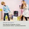 Two children are singing into microphones in a room with a karaoke machine. Produktbild-Vorschau