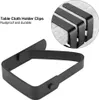 A close-up of black table cloth holder clips, with a magnified inset showing multiple clips on a table cloth. Produktbild-Vorschau