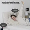 A woman is lying in bed, interacting with a smart thermostat via voice command. Podgląd zdjęcia produktu