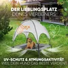 A dog is resting on an elevated dog bed with a canopy in a backyard setting. Produktbild-Vorschau