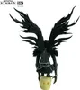 A collectible figure of Ryuk from Death Note, standing on a skull. Voir les images du produit