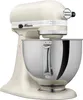 A cream-colored KitchenAid Artisan stand mixer is shown from a side angle against a white background. Produktbild-Vorschau