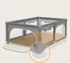 A grey playpen with a brown mat inside, highlighted with orange lines and a close-up of a suction cup at the bottom. Anteprima dell’immagine prodotto