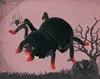 A remote-controlled spider toy with a Halloween-themed background, including a spider web and a bare tree silhouette. A remote control is visible in the foreground. Produktbild-Vorschau