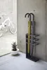 An umbrella stand with two umbrellas in it, next to a concrete wall and a bicycle. Náhľad obrázku produktu