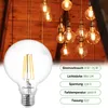 A close-up of an LED light bulb with several vintage-style filament bulbs hanging in the background. Produktbild-Vorschau