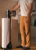 A person is standing next to a vacuum cleaner in a room. Podgląd zdjęcia produktu