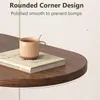 A close-up view of a wooden coffee table with a book and a mug on it, highlighting the rounded corner design. Náhľad obrázku produktu