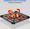 A black grill rack with food items on it, with orange arrows indicating airflow. Produktbild-Vorschau