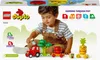 A child playing with a LEGO DUPLO tractor and vegetable toys. Produktbild-Vorschau